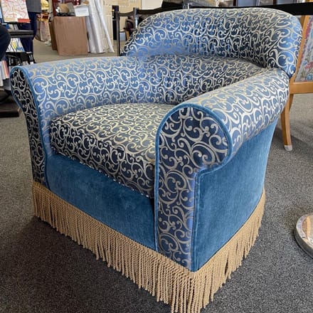 Chair reupholstered with combination of solid and patterned fabric, decorated with fringe