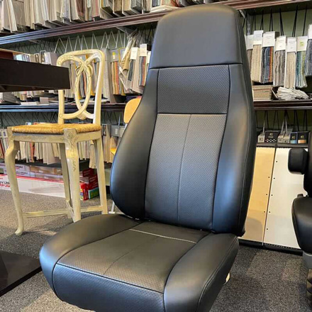 Truck seat reupholstered with black perforated leather