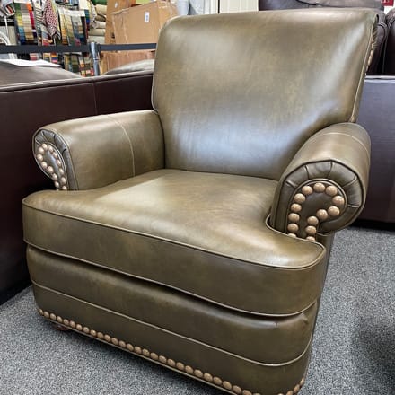 Leather chair reupholstered with green leather and decorated with nailheads