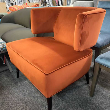 Armless chair reupholstered with oranfe fabric