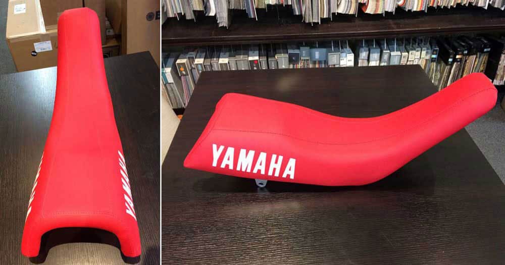 Motorcycle seat reupholstered with red vinyl