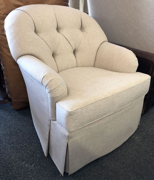 Chair reupholstered with light beige fabric and tufted back